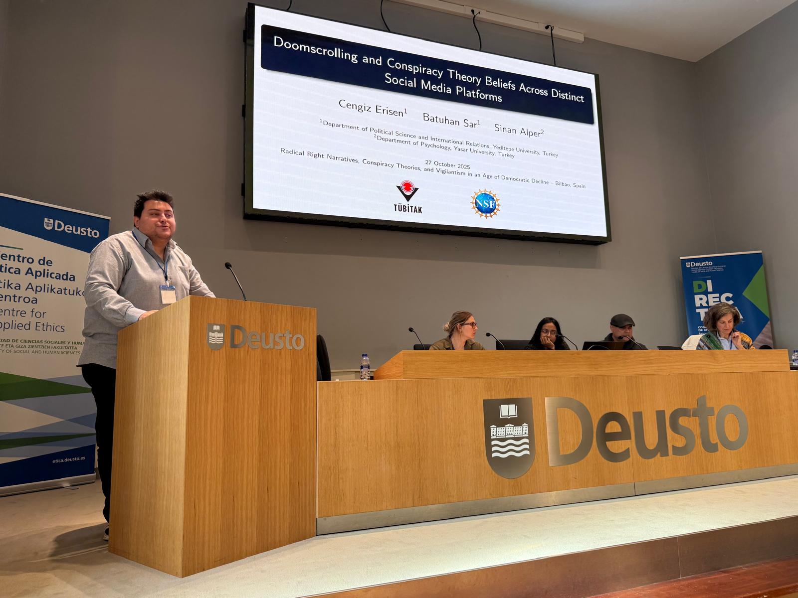 Hüseyin Batuhan Şar presenting research on doomscrolling and conspiracy theory beliefs at the University of Deusto
